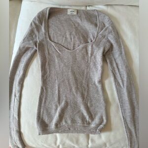 Knit grey long sleeve top with sweetheart neckline. Used in good condition.